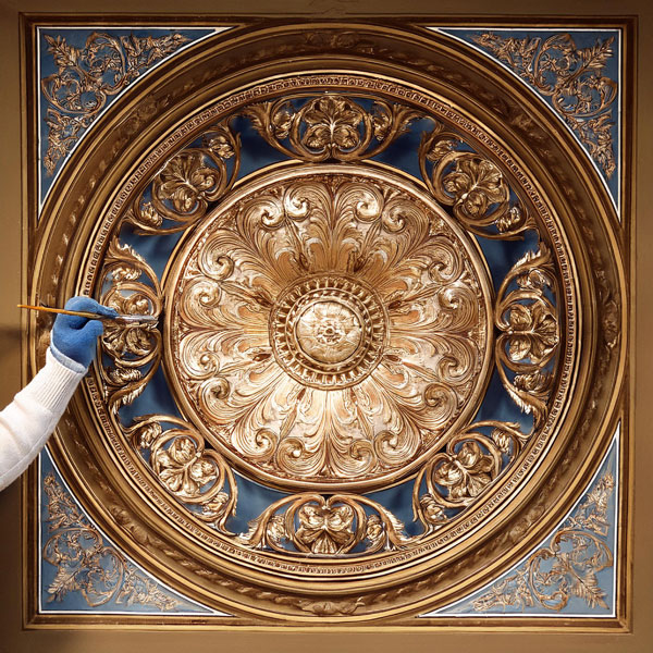 Historical Ceiling Rose being painted by decorator
